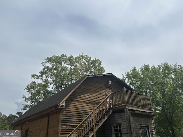 view of side of property featuring a deck and stairway