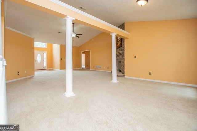 below grade area featuring baseboards, visible vents, a ceiling fan, and a stone fireplace