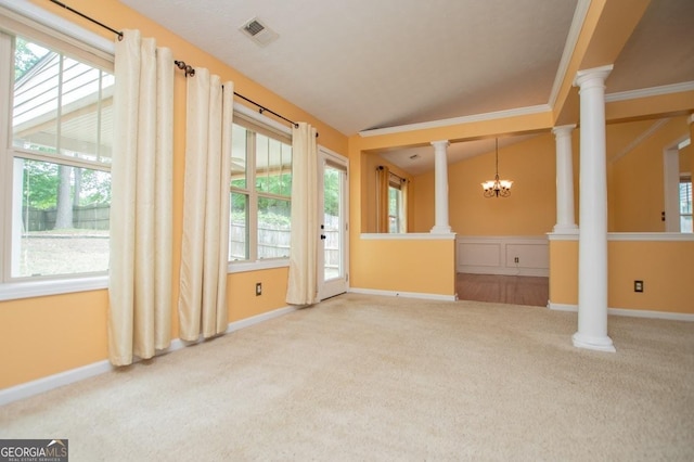 unfurnished living room with ornate columns, carpet floors, an inviting chandelier, vaulted ceiling, and visible vents
