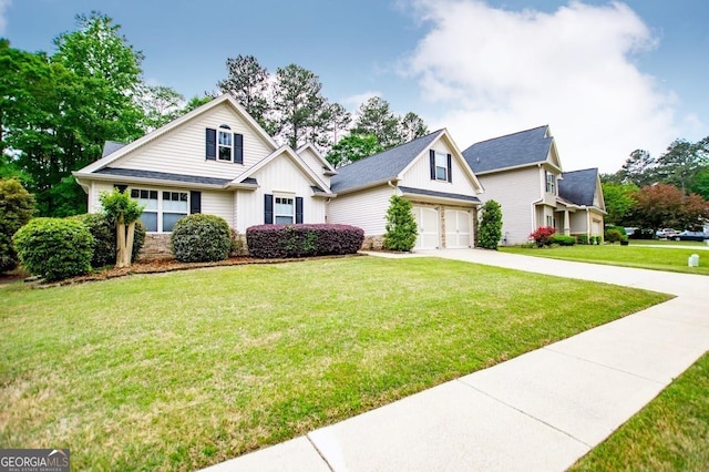 craftsman house with board and batten siding, stone siding, a front lawn, concrete driveway, and an attached garage