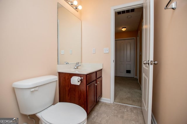 half bath with visible vents, toilet, vanity, and baseboards