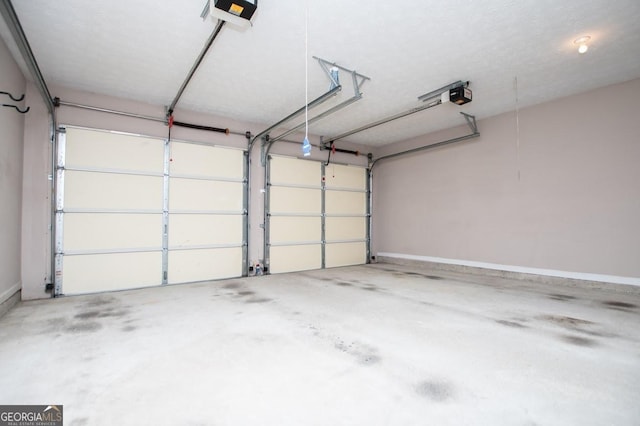 garage with a garage door opener and baseboards