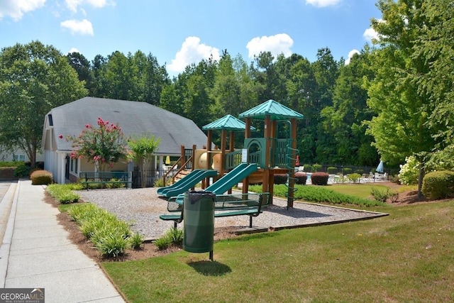 community play area with a yard and fence