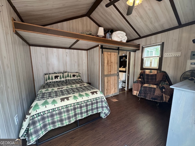 bedroom featuring wooden walls, a ceiling fan, wood finished floors, and lofted ceiling