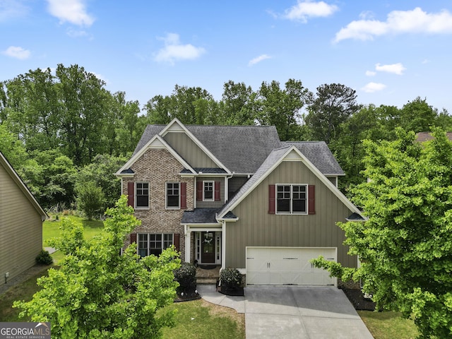 8275 Majors Ridge Way, Cumming, GA 30041 - craftsman inspired home with driveway, board and batten siding, roof with shingles, an attached garage, and view of wooded area