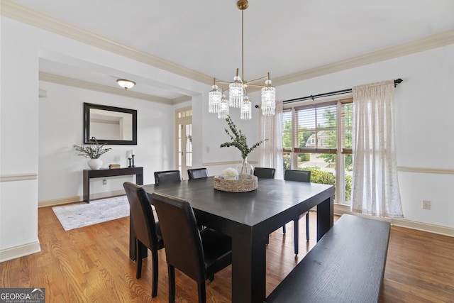8275 Majors Ridge Way, Cumming, GA 30041 - dining space featuring a chandelier, wood finished floors, ornamental molding, and baseboards