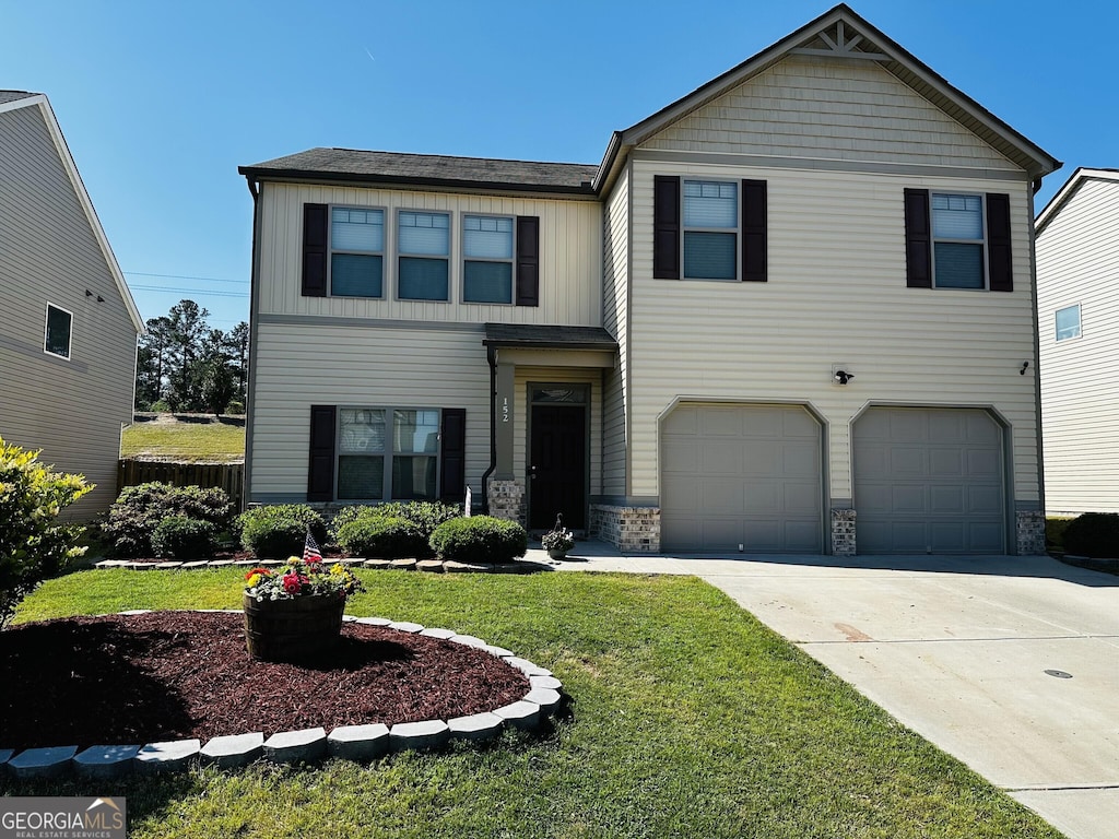 view of front of home featuring board and batten siding, driveway, stone siding, a front yard, and an attached garage