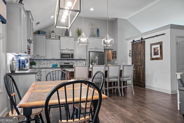 dining area featuring dark wood-type flooring, high vaulted ceiling, a barn door, and baseboards
