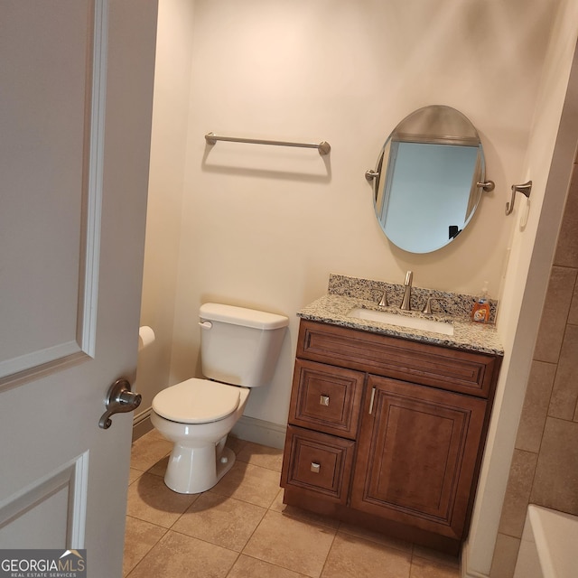 full bath with vanity, a bathtub, tile patterned floors, toilet, and baseboards