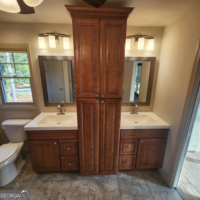 bathroom featuring toilet and vanity