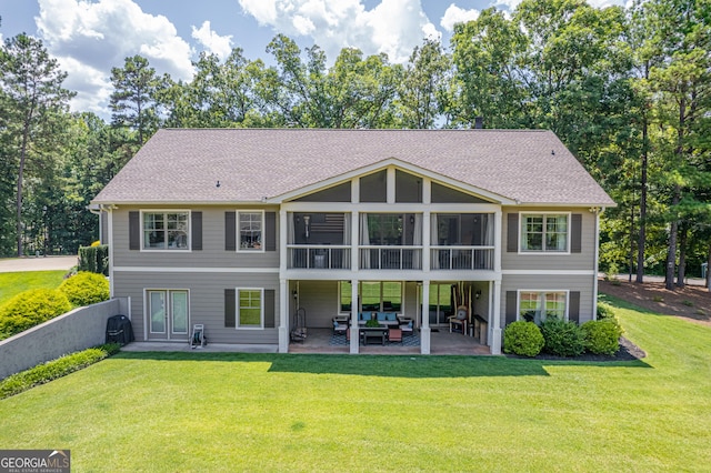 back of house featuring an outdoor living space, a shingled roof, a yard, and a patio area