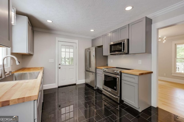 155 Hunters Pointe Dr, Athens, GA 30606 - kitchen with a sink, stainless steel appliances, baseboards, butcher block counters, and gray cabinets