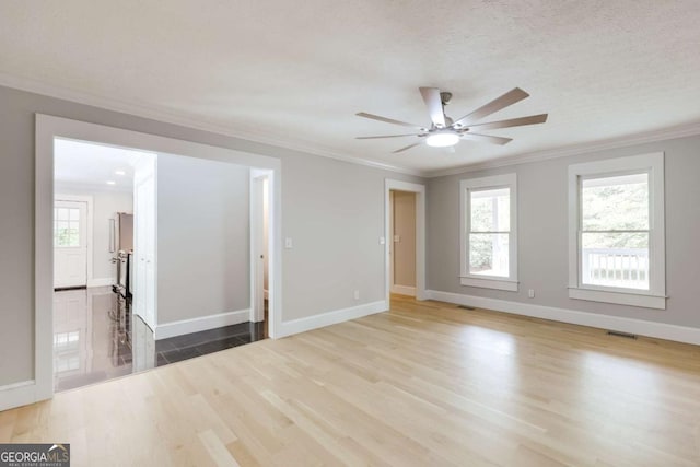 155 Hunters Pointe Dr, Athens, GA 30606 - unfurnished room featuring crown molding, ceiling fan, visible vents, baseboards, and wood finished floors