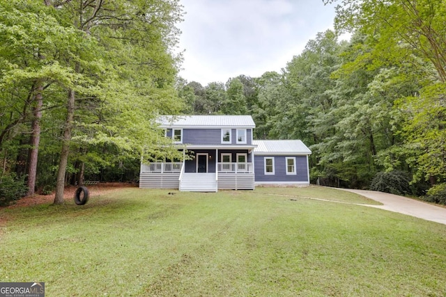 155 Hunters Pointe Dr, Athens, GA 30606 - view of front of property with a front yard, a sunroom, metal roof, a view of trees, and concrete driveway