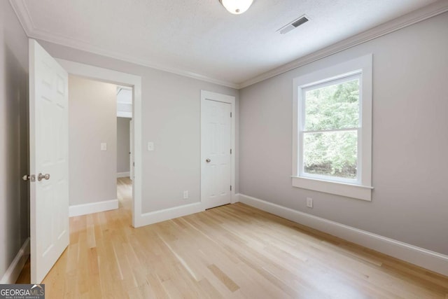 155 Hunters Pointe Dr, Athens, GA 30606 - unfurnished bedroom featuring crown molding, light wood finished floors, visible vents, and baseboards