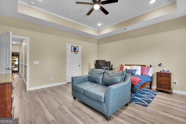 1703 Windsor Rd, Statesboro, GA 30461 - bedroom featuring ornamental molding, a tray ceiling, light wood-style flooring, recessed lighting, and a ceiling fan