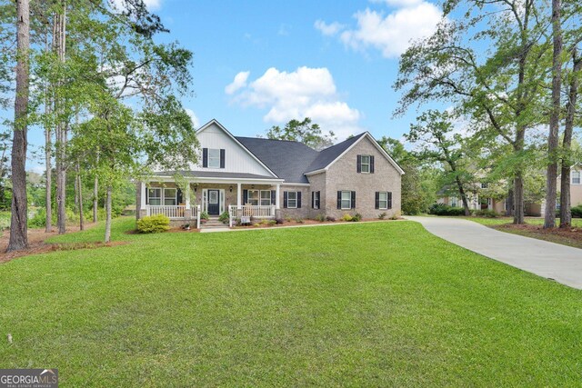 1703 Windsor Rd, Statesboro, GA 30461 - view of front of property featuring covered porch, a front lawn, concrete driveway, and brick siding