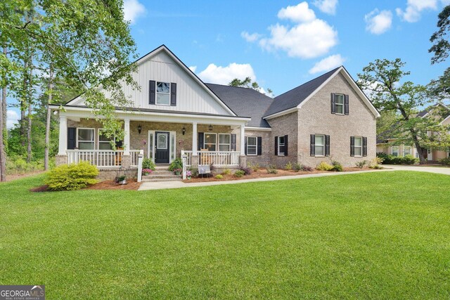 1703 Windsor Rd, Statesboro, GA 30461 - view of front of house with a front lawn, a porch, and brick siding