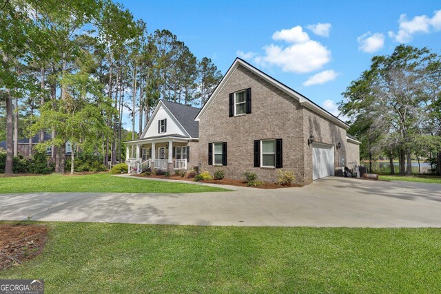 1703 Windsor Rd, Statesboro, GA 30461 - view of property exterior featuring a porch, brick siding, driveway, a yard, and an attached garage