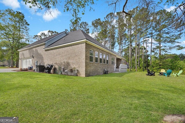 1703 Windsor Rd, Statesboro, GA 30461 - view of side of property featuring brick siding, an attached garage, and a yard