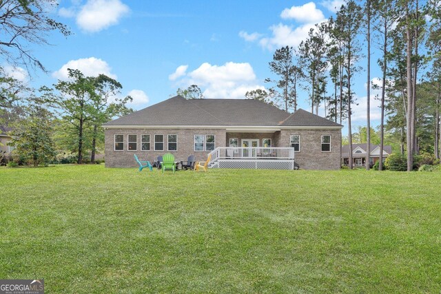 1703 Windsor Rd, Statesboro, GA 30461 - rear view of property with a wooden deck, a yard, and brick siding
