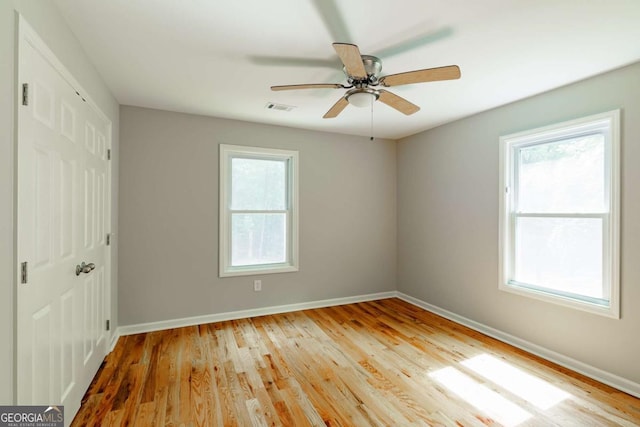 unfurnished bedroom with a closet, visible vents, and multiple windows