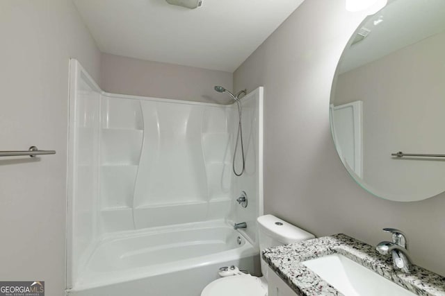 bathroom featuring toilet, bathtub / shower combination, and vanity