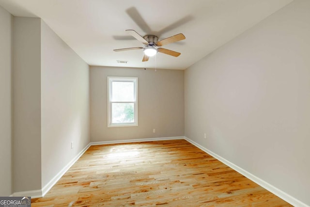 unfurnished room with visible vents, ceiling fan, light wood-style flooring, and baseboards