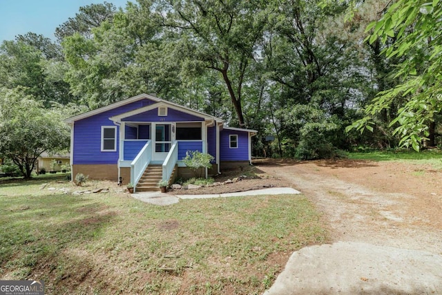 bungalow-style home with a porch and a front yard