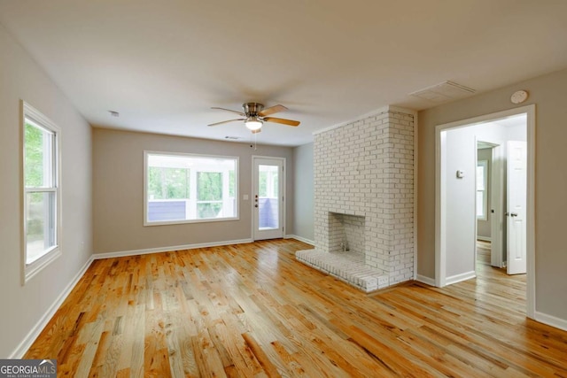 unfurnished living room with light wood finished floors, a ceiling fan, and baseboards
