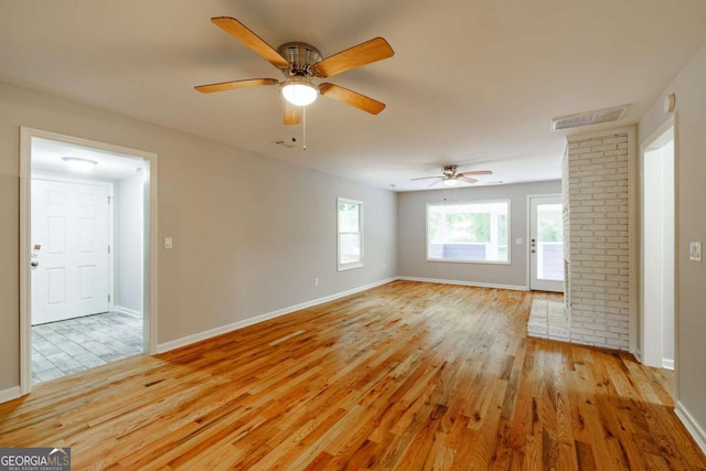 spare room featuring visible vents, baseboards, ceiling fan, and light wood-type flooring