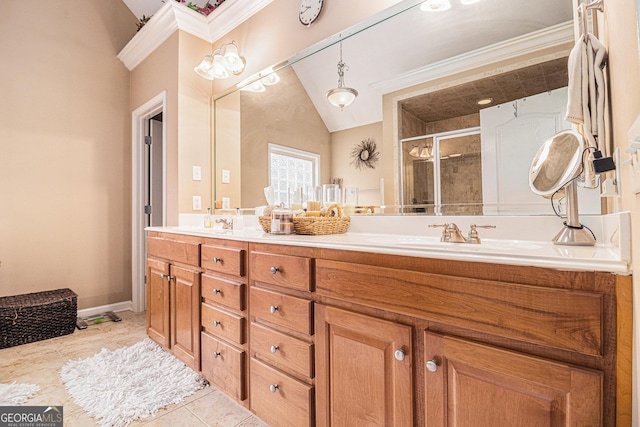 full bathroom featuring a sink, a stall shower, double vanity, vaulted ceiling, and ornamental molding