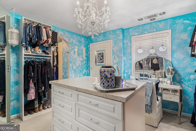 spacious closet featuring visible vents, a notable chandelier, and light carpet