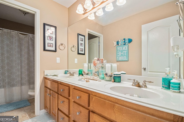 bathroom featuring toilet, a shower with curtain, double vanity, and a sink