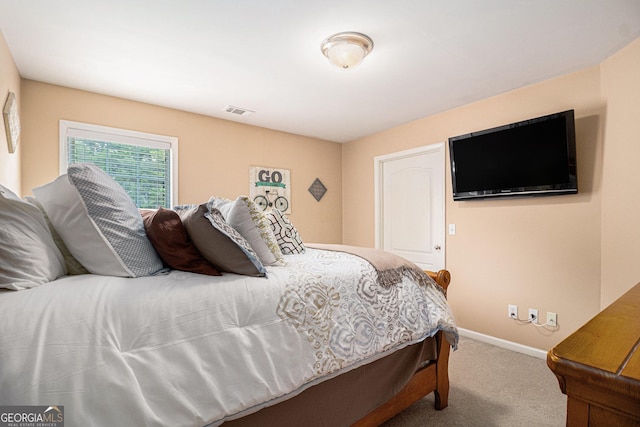 bedroom with visible vents, carpet, and baseboards