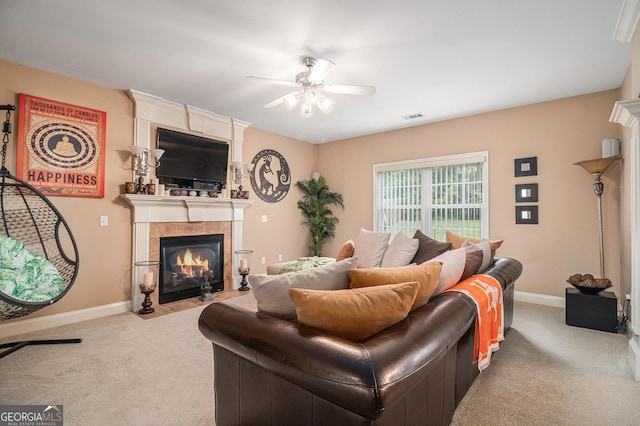 carpeted living area featuring a fireplace, visible vents, ceiling fan, and baseboards