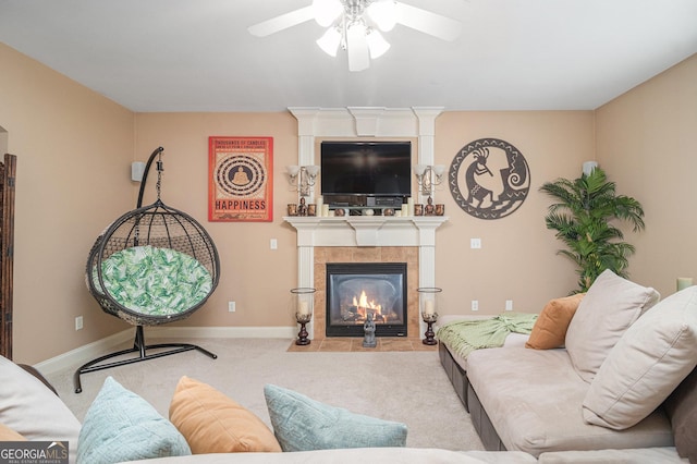 carpeted living room with a tile fireplace, a ceiling fan, and baseboards