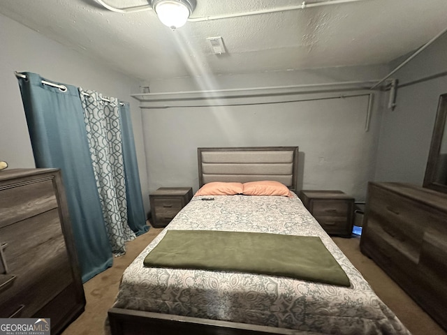 carpeted bedroom featuring visible vents
