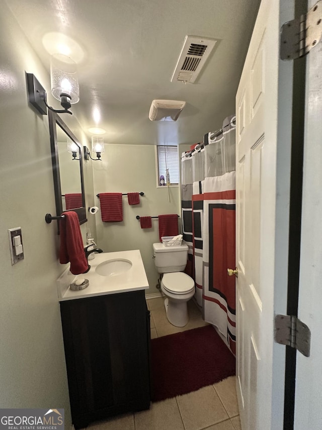 bathroom with visible vents, toilet, tile patterned flooring, and vanity