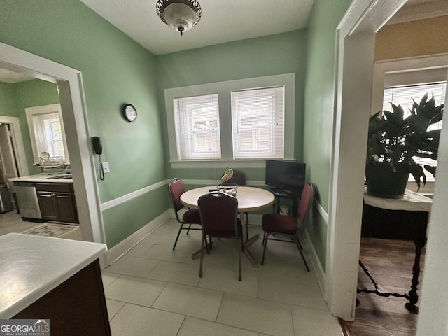dining area with baseboards, light tile patterned floors, and a wealth of natural light