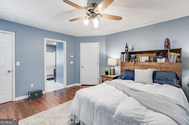 112 Hightower Rd, Hiram, GA 30141 - bedroom with wood finished floors, ceiling fan, a baseboard heating unit, and baseboards