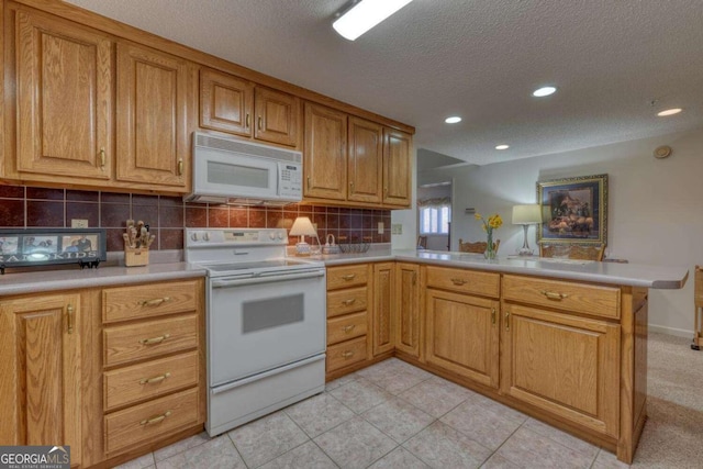 3131 Allison Ct Unit 3A, Young Harris, GA 30582 - kitchen featuring a textured ceiling, decorative backsplash, light countertops, white appliances, and a peninsula