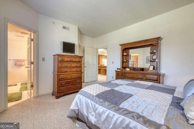 3131 Allison Ct Unit 3A, Young Harris, GA 30582 - carpeted bedroom with visible vents, ensuite bath, a textured ceiling, and lofted ceiling