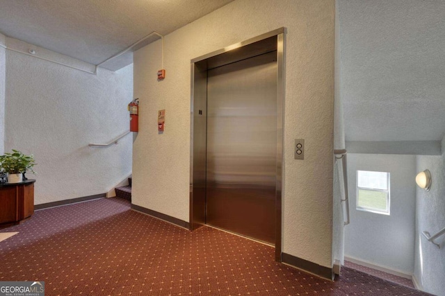 3131 Allison Ct Unit 3A, Young Harris, GA 30582 - corridor featuring elevator, a textured wall, baseboards, carpet, and stairs