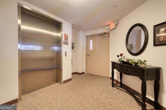 3131 Allison Ct Unit 3A, Young Harris, GA 30582 - corridor featuring carpet flooring, a textured wall, elevator, baseboards, and a textured ceiling