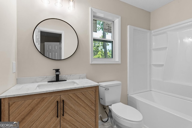 bathroom with bathing tub / shower combination, toilet, and vanity