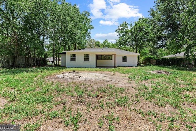 back of house featuring a fenced backyard