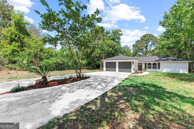 view of front facade with a front lawn, driveway, and a garage