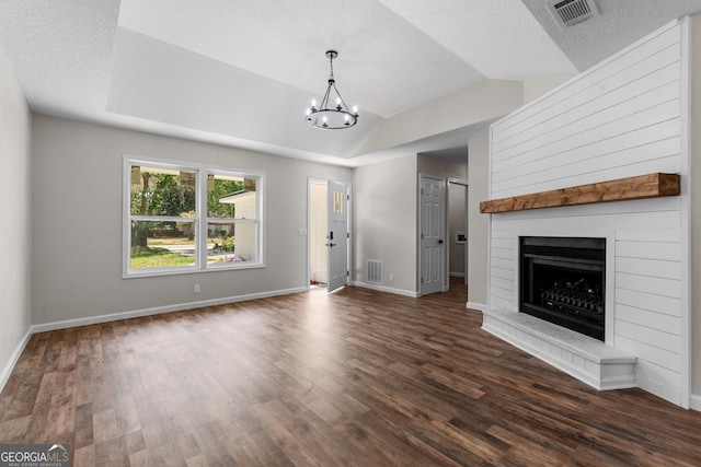 unfurnished living room with dark wood finished floors, visible vents, and an inviting chandelier