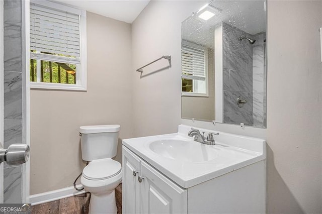 full bath with vanity, toilet, baseboards, walk in shower, and wood finished floors
